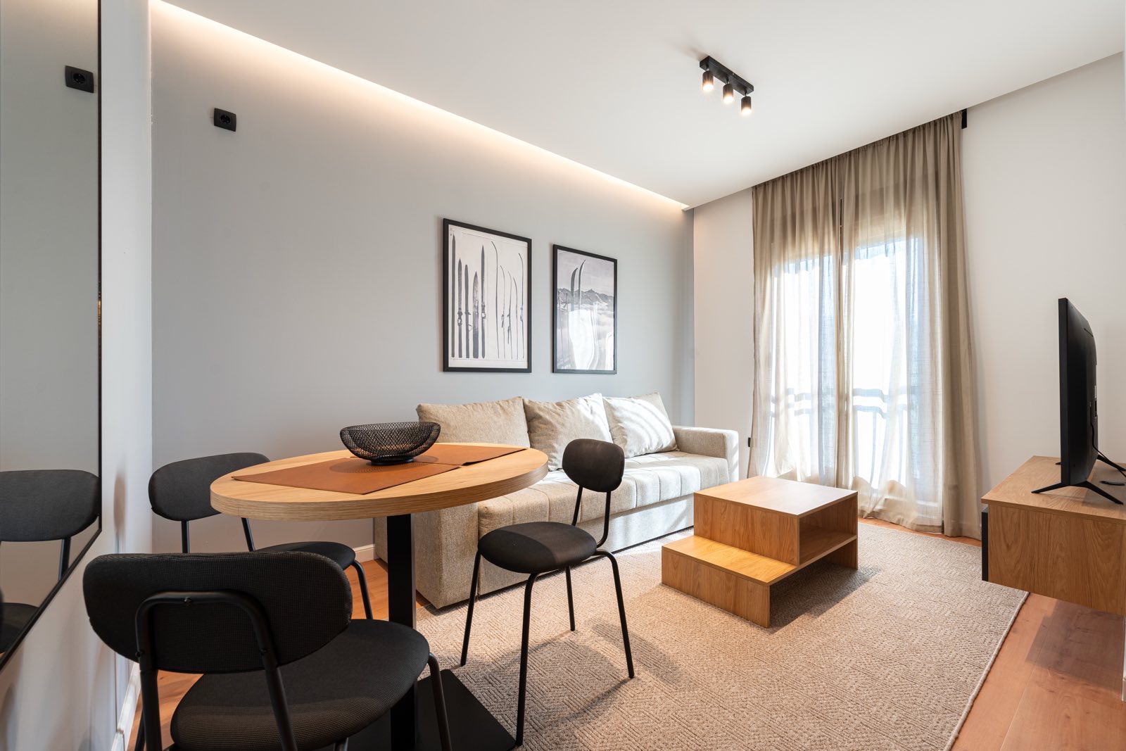 Living room with sofa, dining table and balcony doors